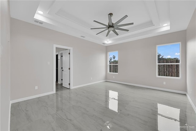 empty room with ceiling fan, visible vents, baseboards, a tray ceiling, and recessed lighting