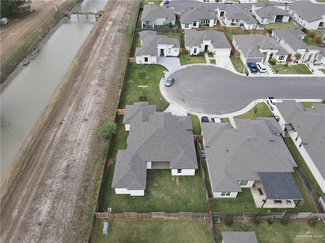 birds eye view of property with a water view and a residential view