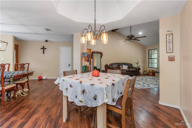 dining space with ceiling fan with notable chandelier, dark hardwood / wood-style flooring, and lofted ceiling