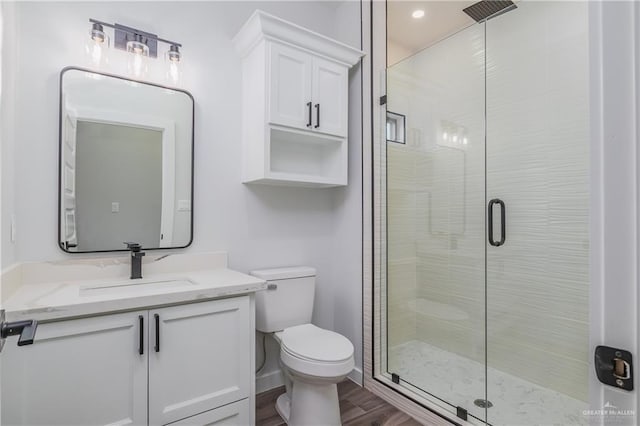 2316 Piedra St, Edinburg, TX 78542 - full bathroom featuring toilet, a stall shower, vanity, wood finished floors, and recessed lighting