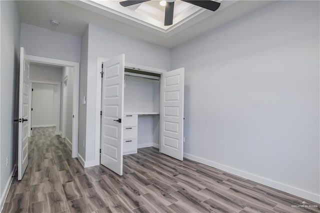 2316 Piedra St, Edinburg, TX 78542 - unfurnished bedroom with wood finished floors, baseboards, a closet, and a ceiling fan