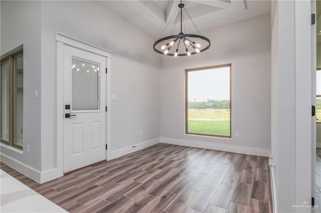 2316 Piedra St, Edinburg, TX 78542 - unfurnished dining area featuring a chandelier, wood finished floors, and baseboards
