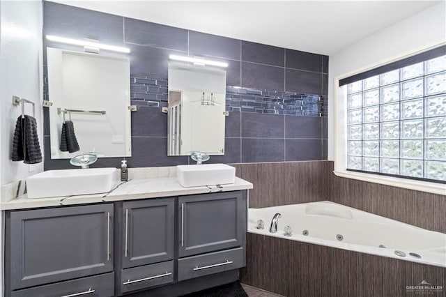 bathroom featuring vanity and independent shower and bath