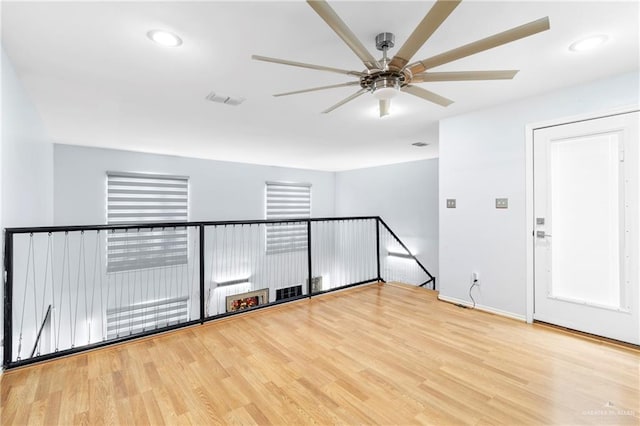 spare room featuring light hardwood / wood-style floors and ceiling fan