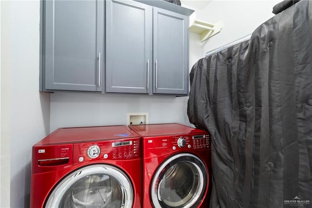 washroom featuring cabinets and independent washer and dryer