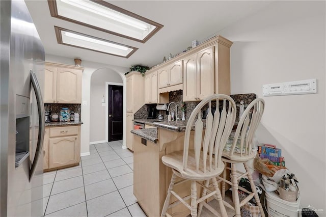 3704 San Gerardo St, Mission, TX 78572 - kitchen with a peninsula, stainless steel fridge, tasteful backsplash, and a kitchen bar