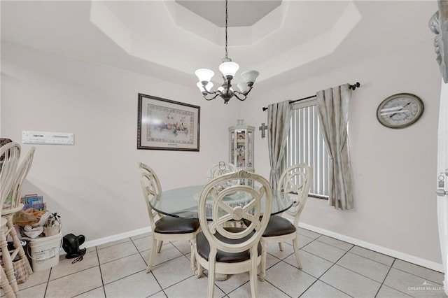 3704 San Gerardo St, Mission, TX 78572 - dining area with baseboards, a tray ceiling, an inviting chandelier, and light tile patterned floors