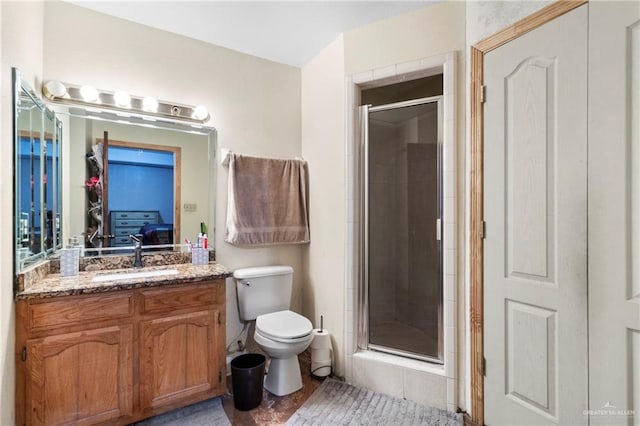 bathroom with vanity, toilet, and walk in shower