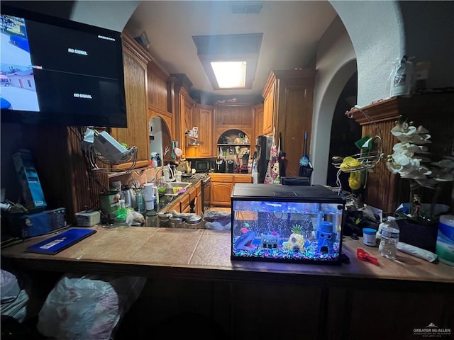 kitchen with tile counters and sink