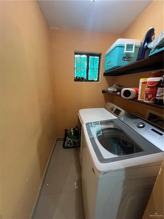 laundry area with tile patterned flooring and separate washer and dryer