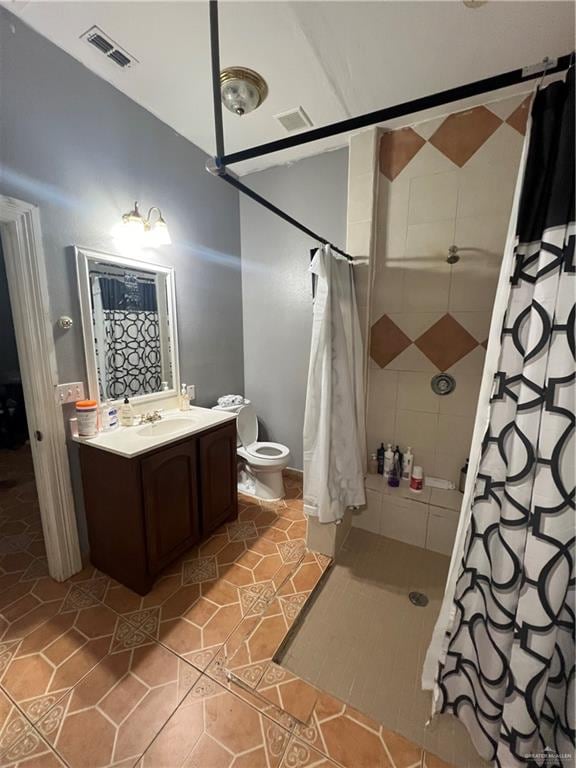 bathroom featuring tile patterned flooring, vanity, a shower with shower curtain, and toilet