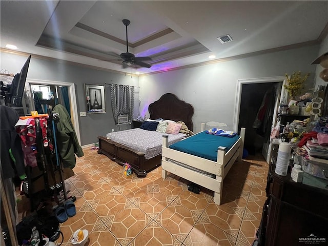 bedroom featuring a raised ceiling, ceiling fan, and ornamental molding