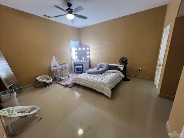 tiled bedroom featuring ceiling fan