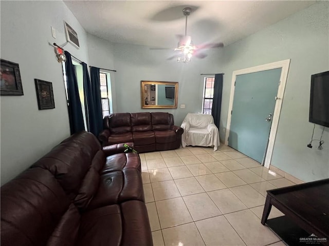 tiled living room featuring ceiling fan and plenty of natural light