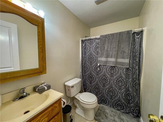 bathroom with tile patterned flooring, vanity, curtained shower, and toilet