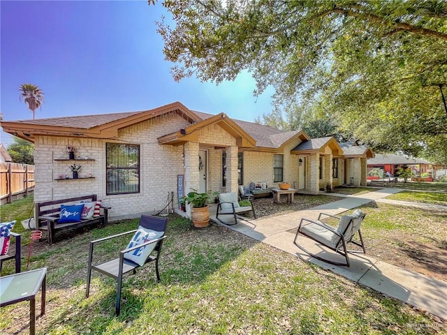 rear view of house featuring a patio area and a lawn