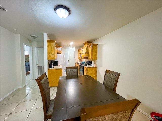 dining area featuring light tile patterned flooring