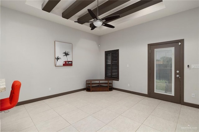 spare room with ceiling fan and light tile patterned floors