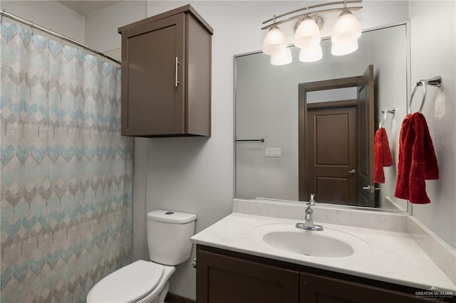 bathroom with walk in shower, vanity, and toilet