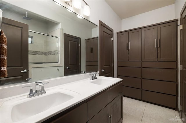 bathroom featuring tile patterned flooring, a shower, and vanity