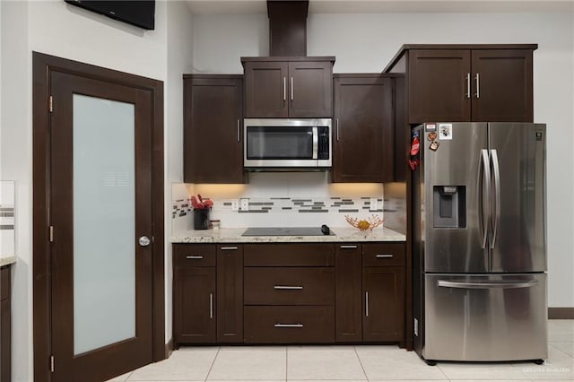 kitchen featuring appliances with stainless steel finishes, light stone counters, tasteful backsplash, and dark brown cabinetry