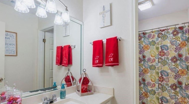 bathroom featuring walk in shower and vanity