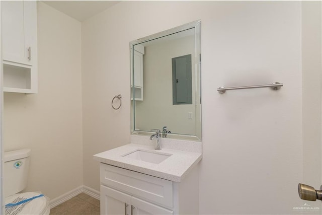 bathroom featuring vanity, tile patterned flooring, electric panel, and toilet