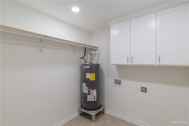 clothes washing area with water heater, electric dryer hookup, washer hookup, and cabinets