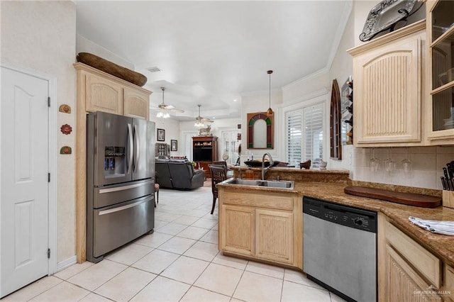 5512 Autumn Mist Ln, Brownsville, TX 78526 - kitchen with appliances with stainless steel finishes, light brown cabinetry, open floor plan, light tile patterned flooring, and crown molding