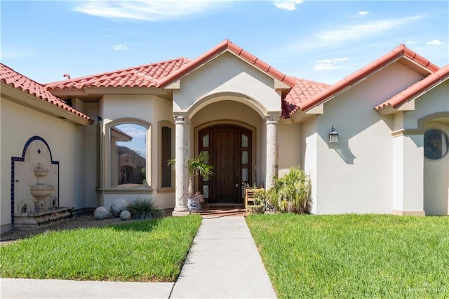 5512 Autumn Mist Ln, Brownsville, TX 78526 - property entrance featuring stucco siding, a yard, and a tile roof