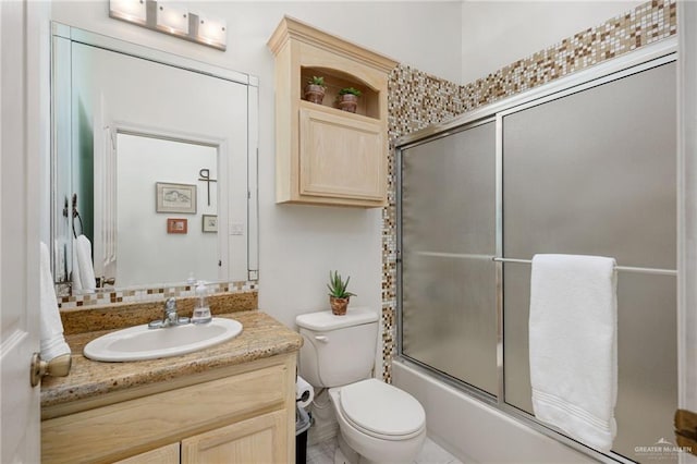 5512 Autumn Mist Ln, Brownsville, TX 78526 - bathroom featuring vanity, bath / shower combo with glass door, and decorative backsplash