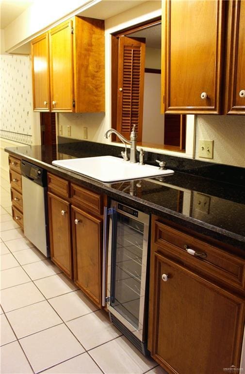 kitchen featuring light tile patterned flooring, sink, dark stone countertops, dishwasher, and beverage cooler