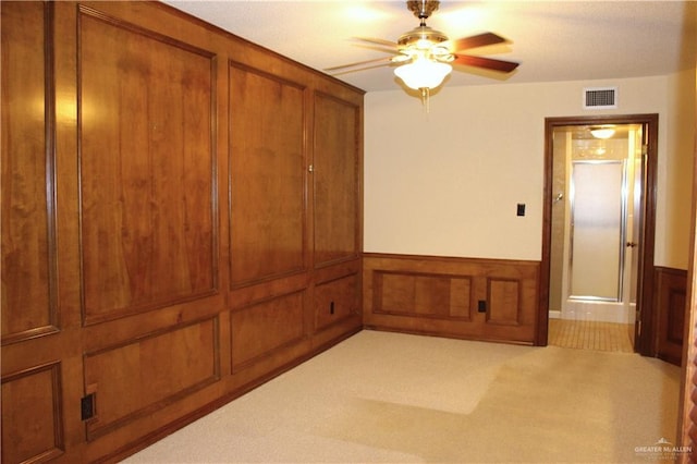 carpeted spare room featuring ceiling fan