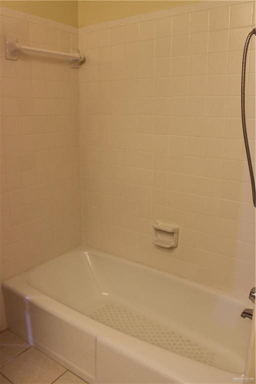 bathroom featuring tile patterned flooring and tiled shower / bath combo