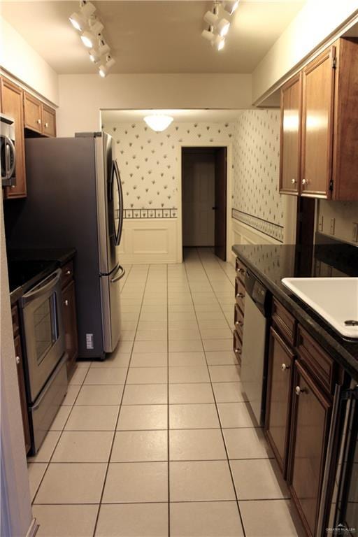 kitchen featuring appliances with stainless steel finishes, sink, and light tile patterned floors