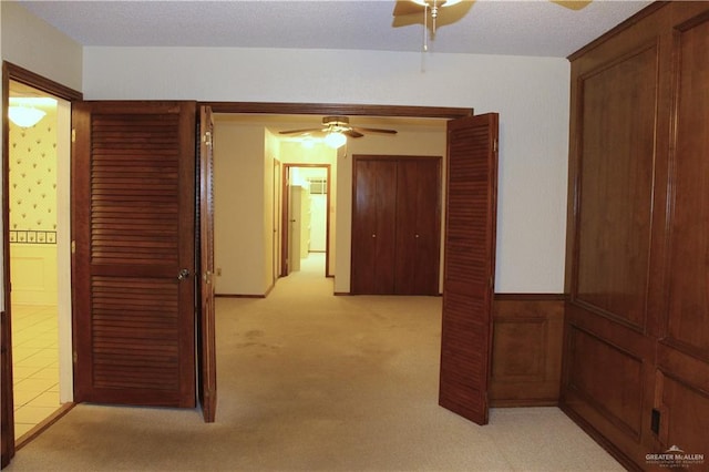 hallway featuring light colored carpet