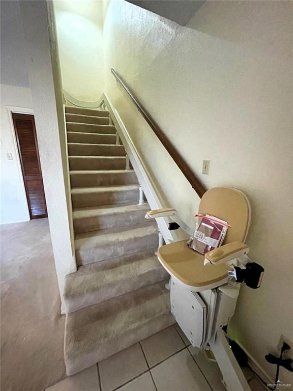 stairway with tile patterned flooring