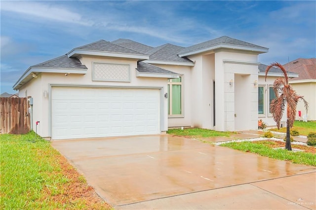 view of front facade with a shingled roof, concrete driveway, an attached garage, fence, and stucco siding