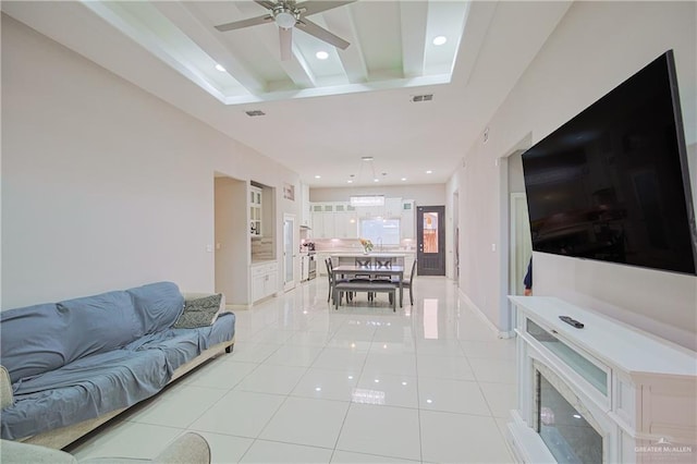 living room with light tile patterned floors, beamed ceiling, and recessed lighting