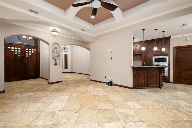 interior space with appliances with stainless steel finishes, pendant lighting, ornamental molding, coffered ceiling, and ceiling fan