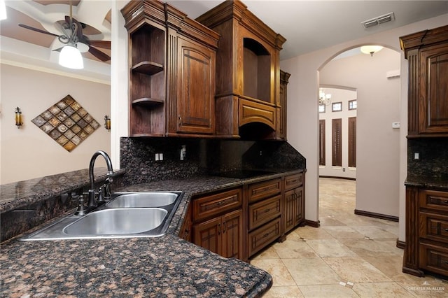 kitchen with sink, backsplash, black electric stovetop, and ceiling fan