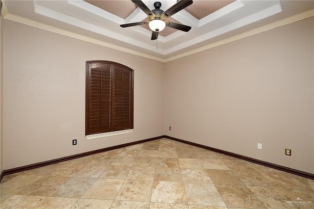 spare room featuring ornamental molding, ceiling fan, and a tray ceiling