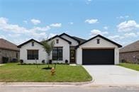 view of front of property featuring a front yard and a garage