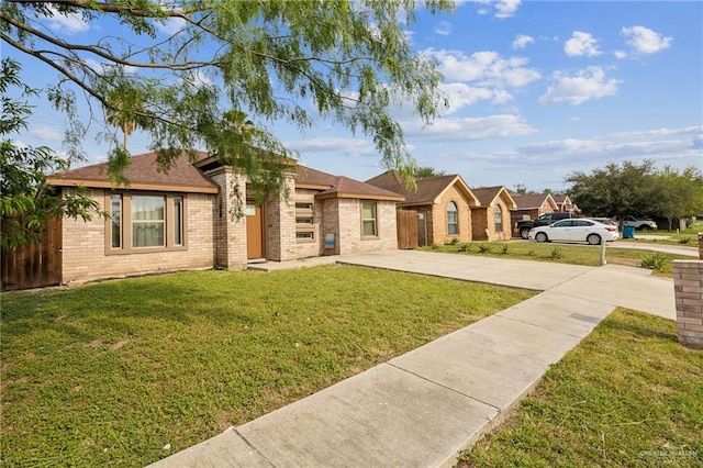 612 Valencia Ln, Brownsville, TX 78521 - view of front facade with driveway and brick siding