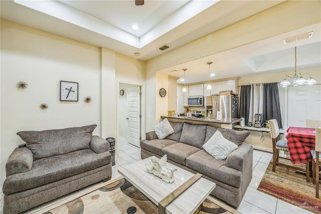 612 Valencia Ln, Brownsville, TX 78521 - living area with a raised ceiling, light tile patterned floors, recessed lighting, and a chandelier