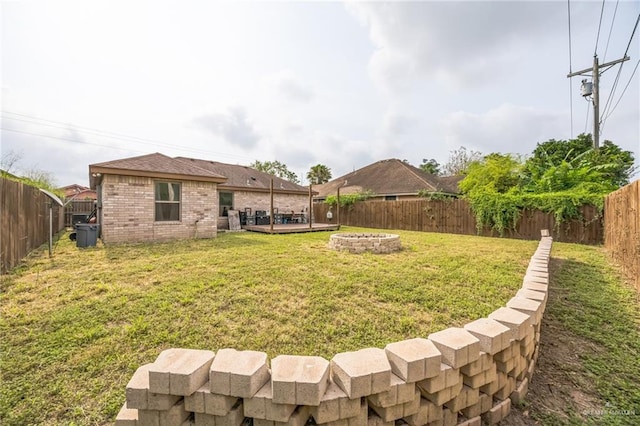 612 Valencia Ln, Brownsville, TX 78521 - view of yard with a fire pit and a wooden deck