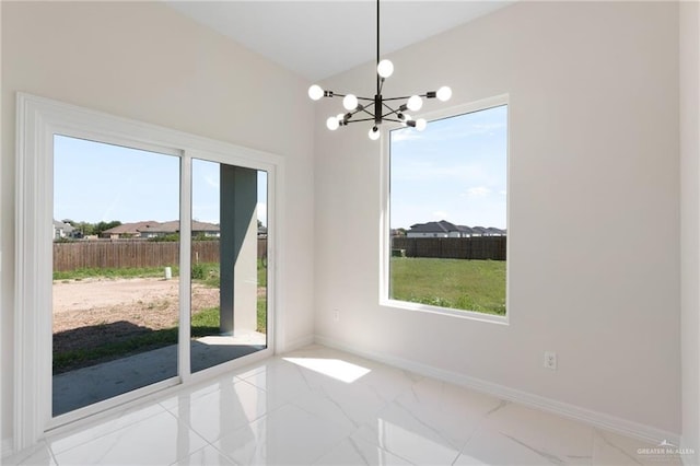 2203 San Charbel St, San Juan, TX 78589 - unfurnished dining area featuring a chandelier, a wealth of natural light, marble finish floor, and baseboards
