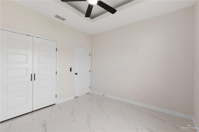 2203 San Charbel St, San Juan, TX 78589 - unfurnished bedroom with a closet, baseboards, a ceiling fan, visible vents, and marble finish floor