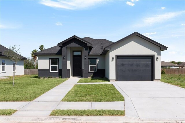 2203 San Charbel St, San Juan, TX 78589 - view of front facade featuring stucco siding, driveway, a front lawn, a garage, and fence