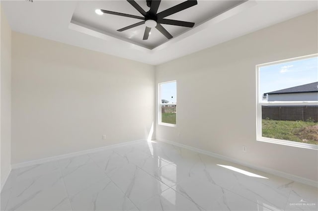 2203 San Charbel St, San Juan, TX 78589 - spare room featuring a raised ceiling, ceiling fan, marble finish floor, and baseboards